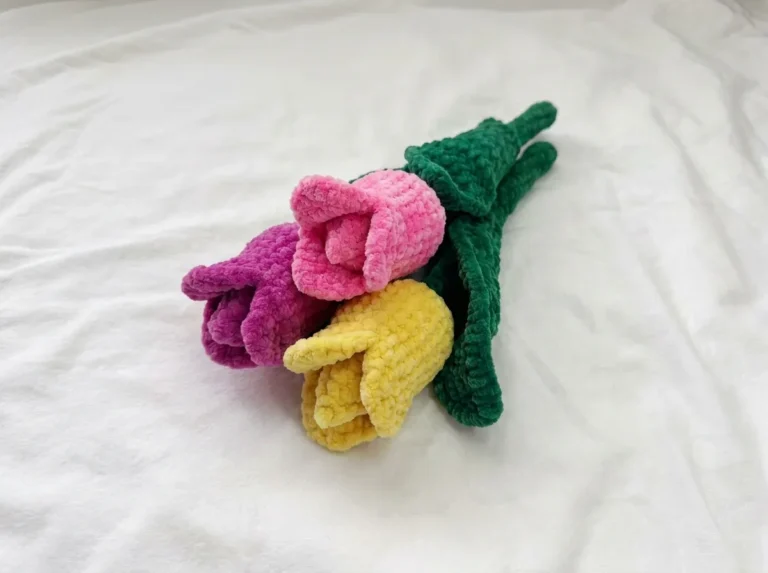Pink, yellow, and purple velvet tulips on white fabric from this tulip crochet pattern.