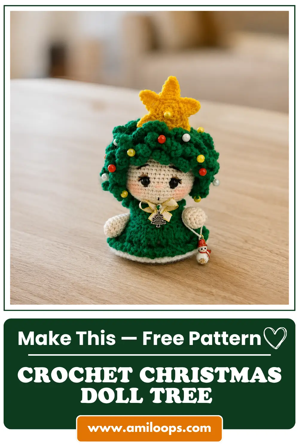 Green crochet christmas tree amigurumi doll with yellow star topper and snowman charm sitting on a light wooden table