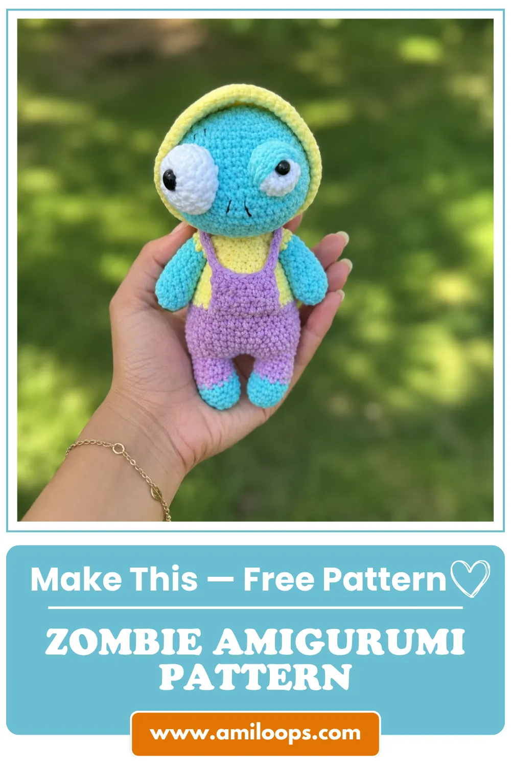 Hand holding a blue crochet doll with purple overalls outdoors for a free zombie amigurumi pattern.