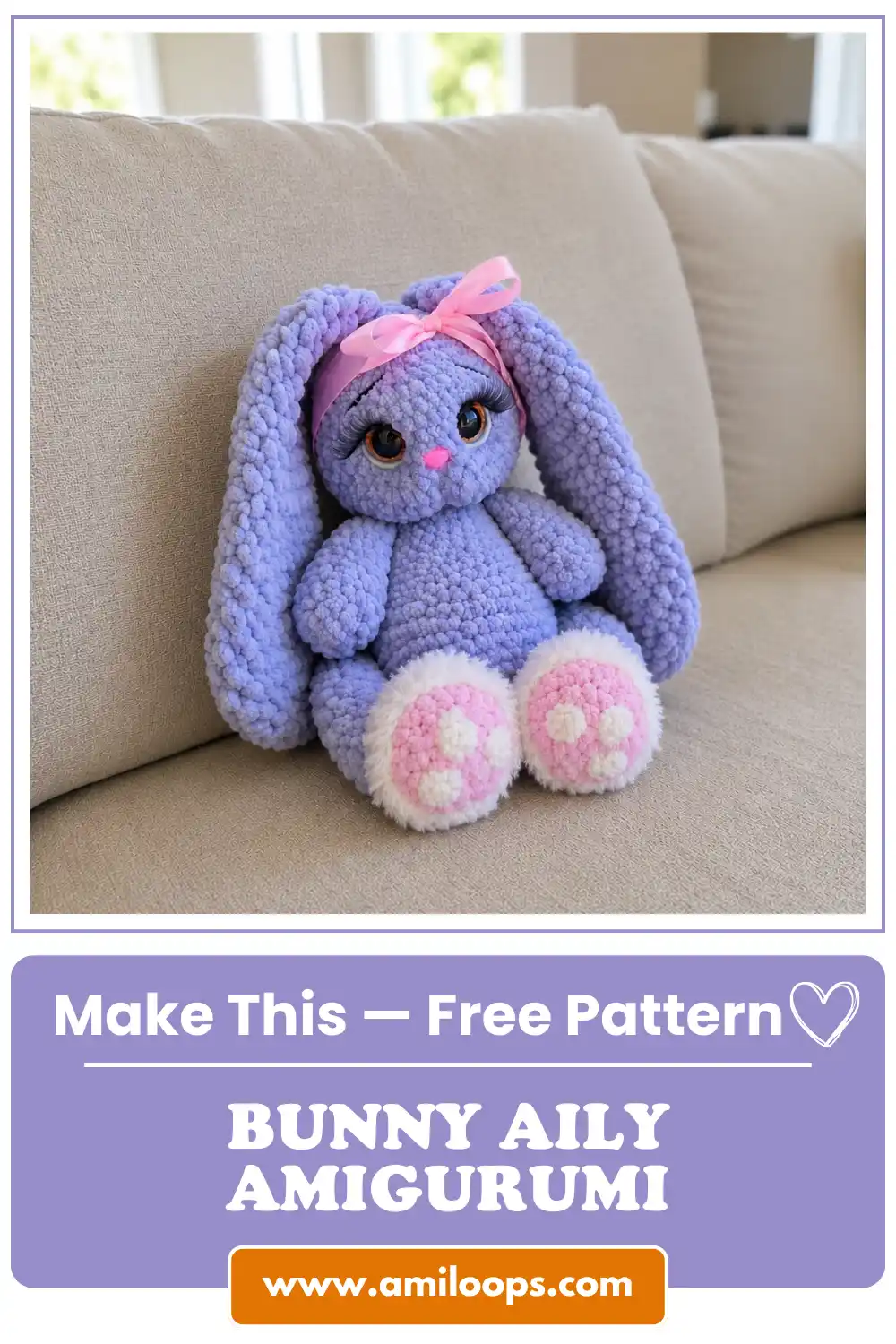 Fluffy purple plush toy sitting on a beige couch, made using the bunny aily amigurumi free pattern.