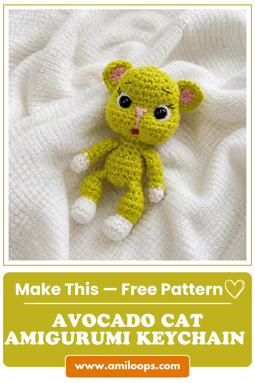 Bright green crocheted avocado cat amigurumi keychain free pattern figure lying on a textured white knitted blanket.