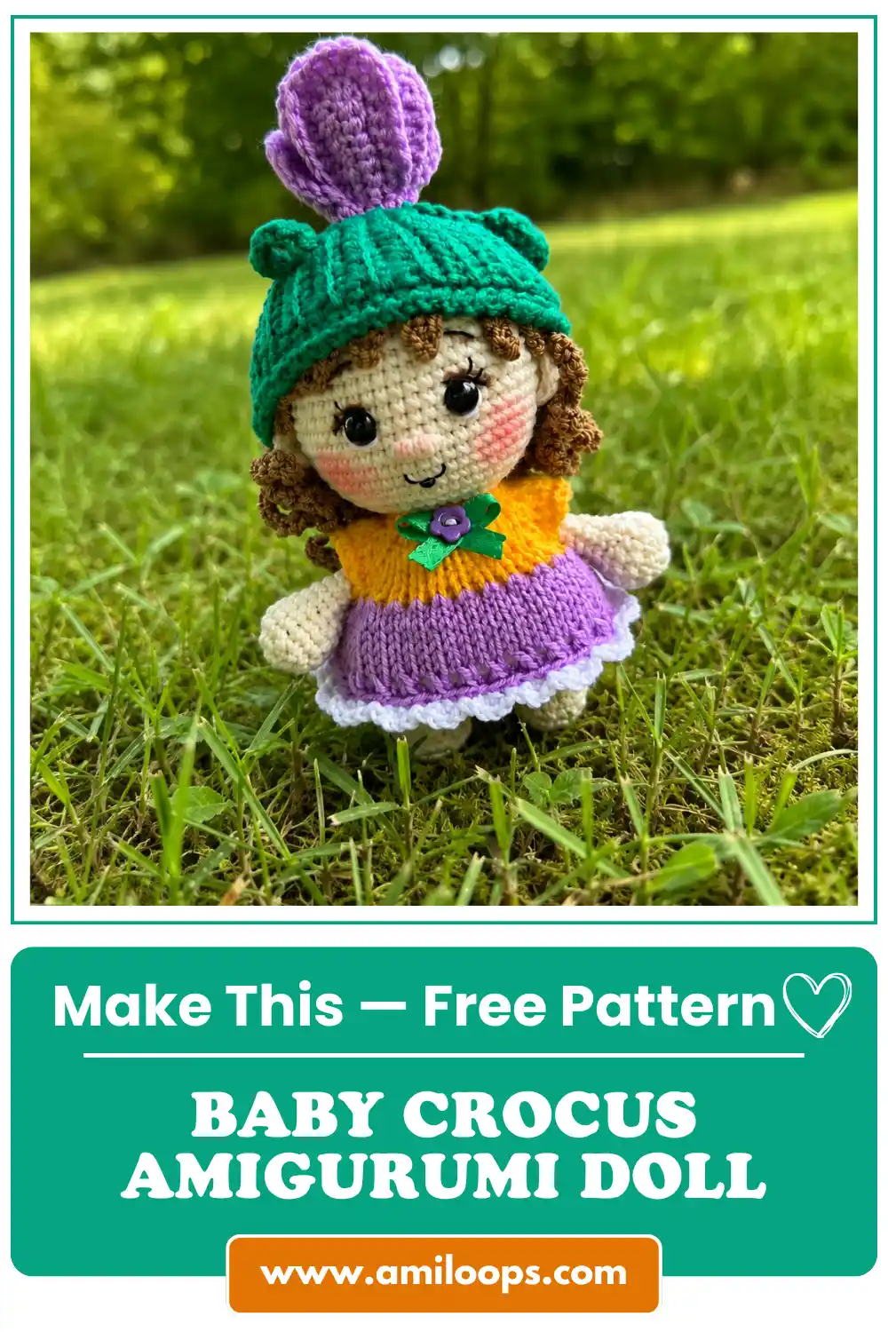 Baby crocus amigurumi doll in green ribbed beanie with purple flower standing outdoors on green lawn grass.
