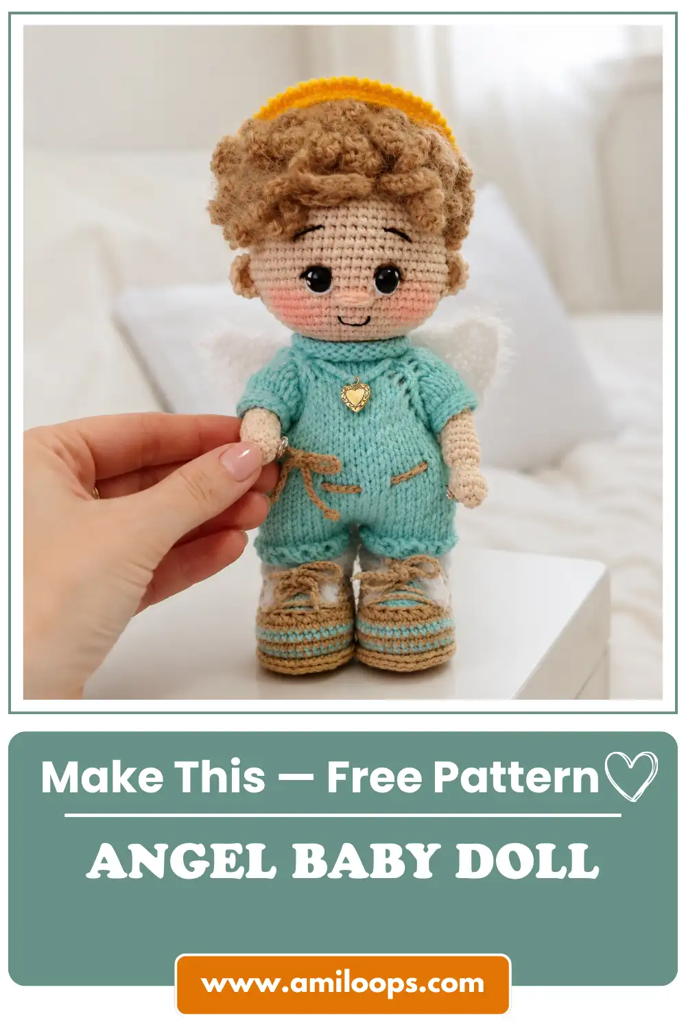 A hand holds this crochet angel baby doll amigurumi pattern free, featuring fluffy wings, blue clothes, and tan shoes.