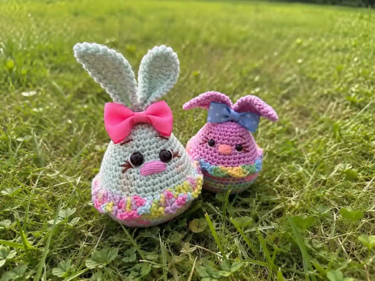 Two crochet Easter bunnies in pastel yarn, one with a melange skirt and bow, one in solid fur.