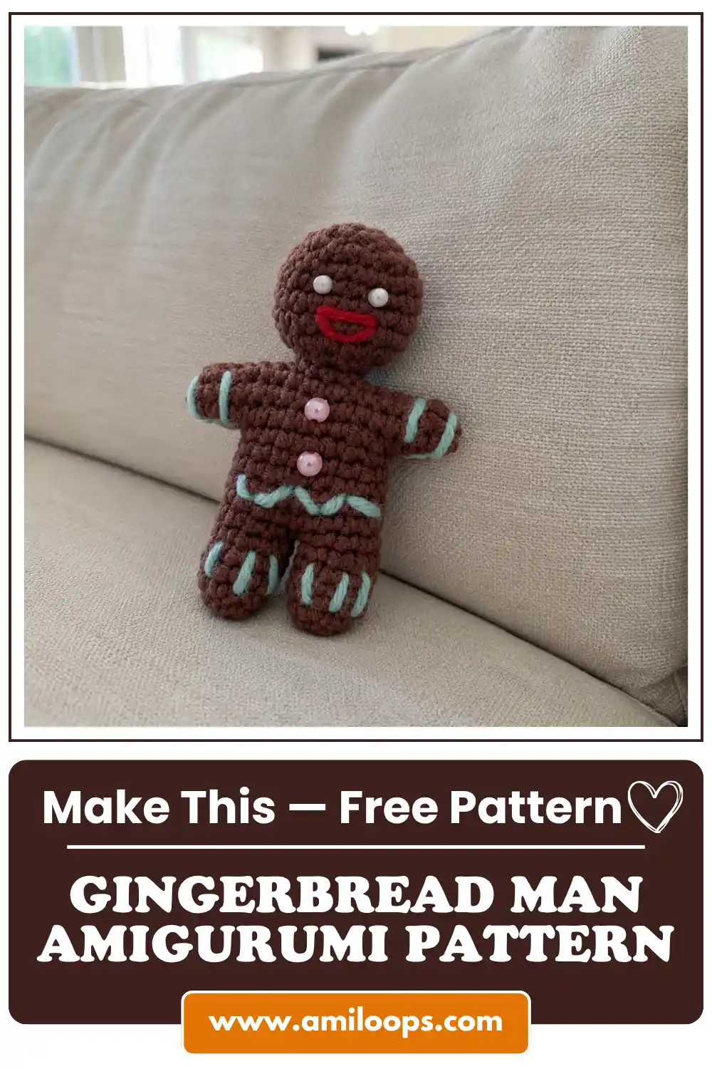 Crocheted brown gingerbread man amigurumi free pattern standing against a beige fabric couch, showing blue icing details.