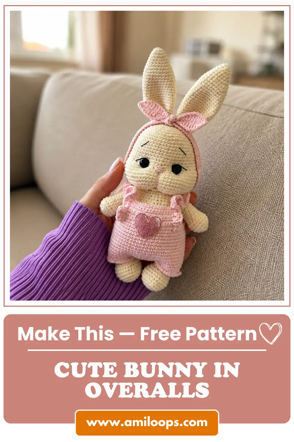 Hand in purple sleeve holds a cream toy over a couch. Try our cute bunny amigurumi free pattern with pink heart overalls.