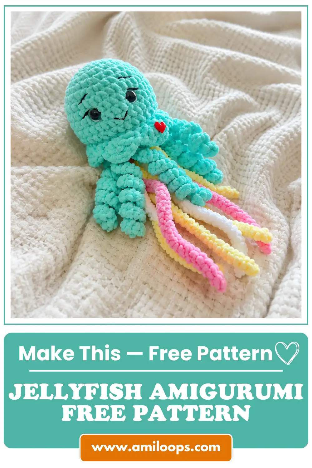 Mint green plush yarn jellyfish amigurumi free pattern lying on a white blanket with pink, yellow, and white tentacles.