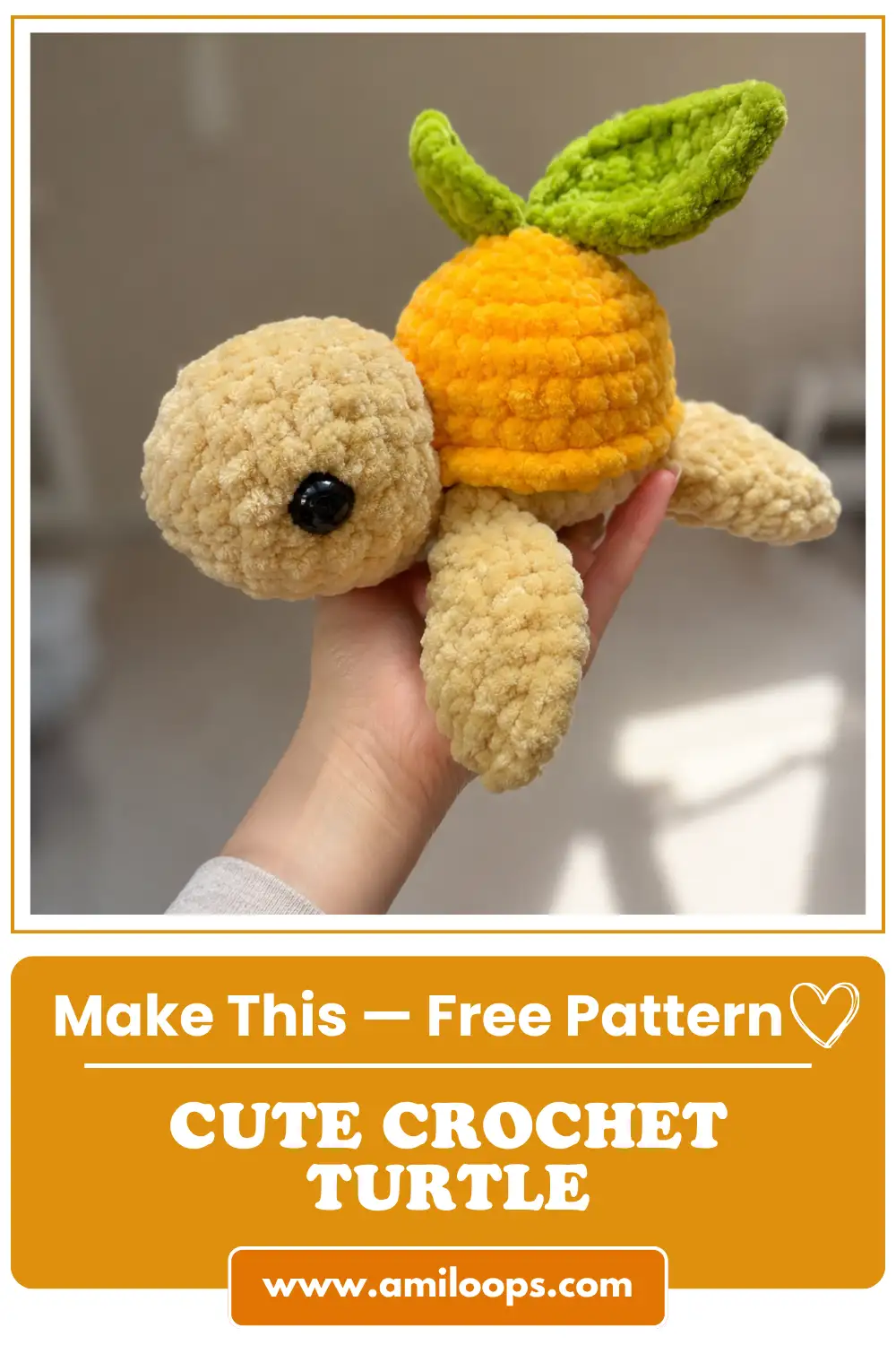 Hand holding an orange and tan chunky yarn turtle with green leaves from our mini turtle crochet pattern free.