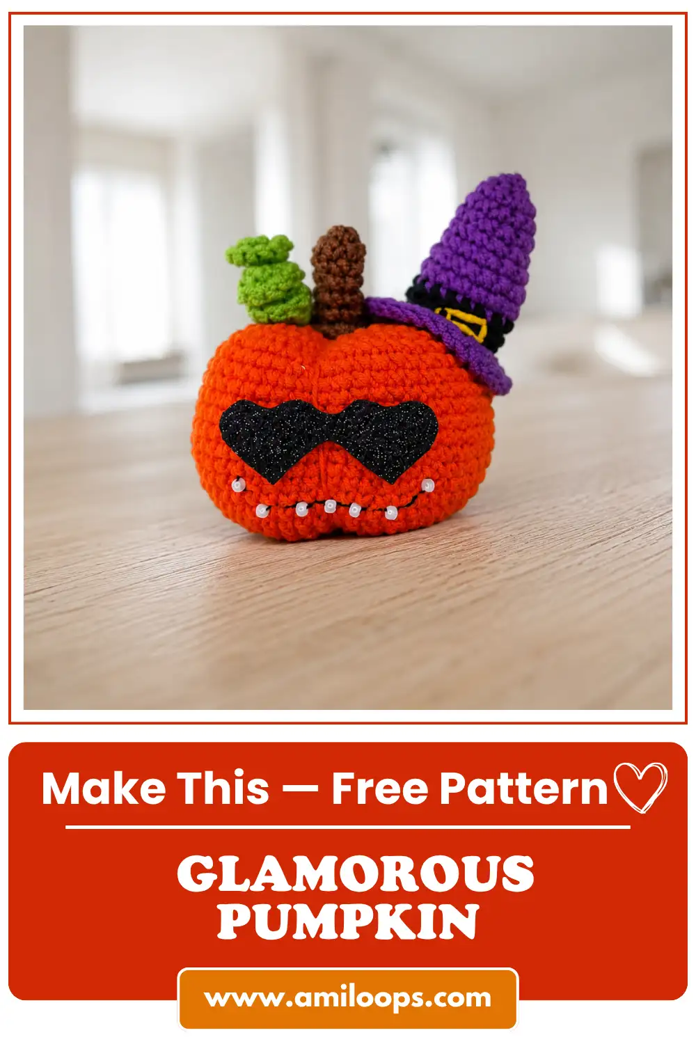 Finished glam pumpkin amigurumi free pattern on a wood table, featuring orange yarn, a purple witch hat, and sunglasses.