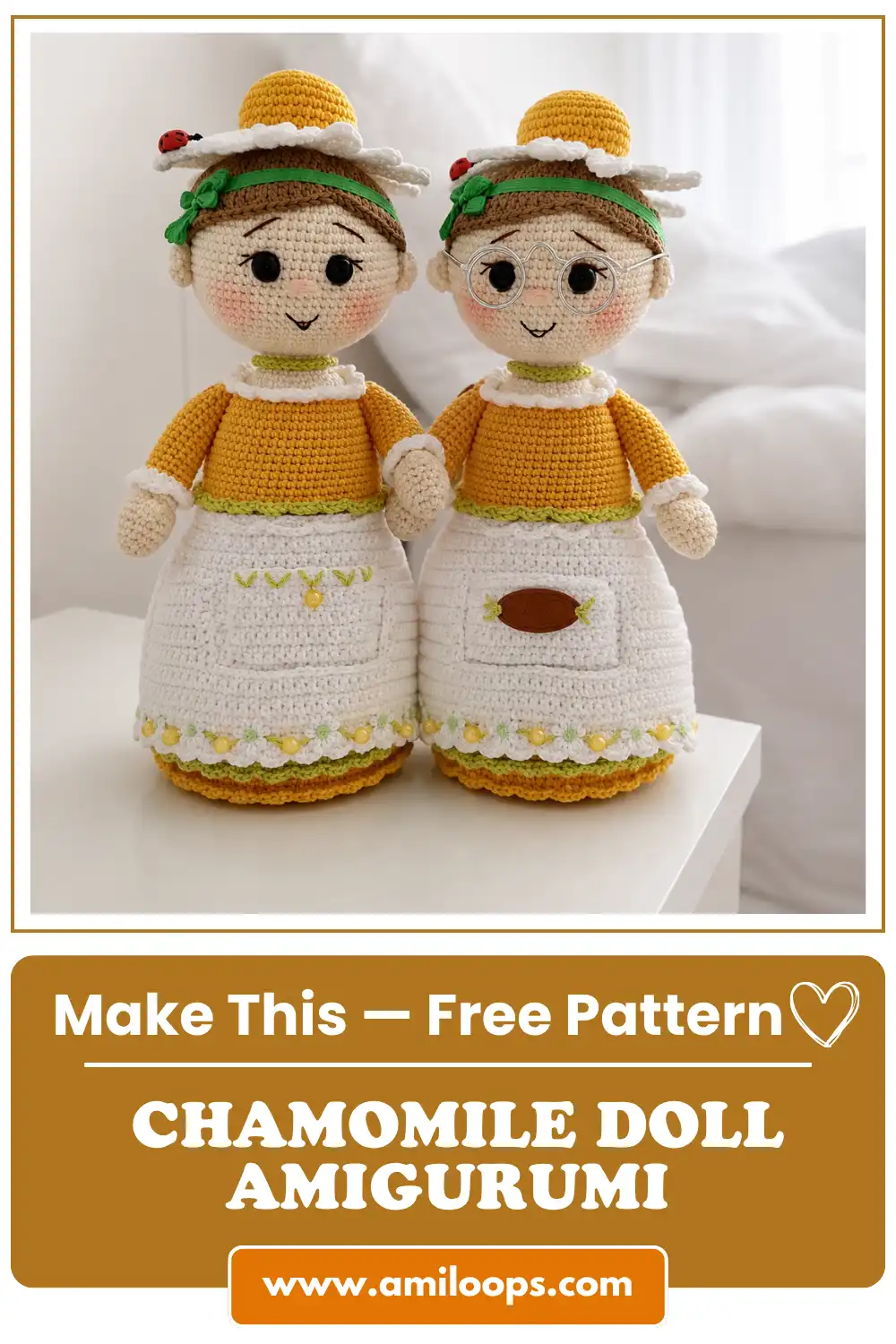 Two matching yarn dolls sit on a white desk showcasing the chamomile doll amigurumi free pattern with flower hats.