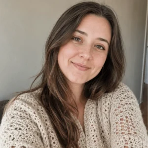 Lily from AmiLoops smiling in a handmade cream crochet cardigan.
