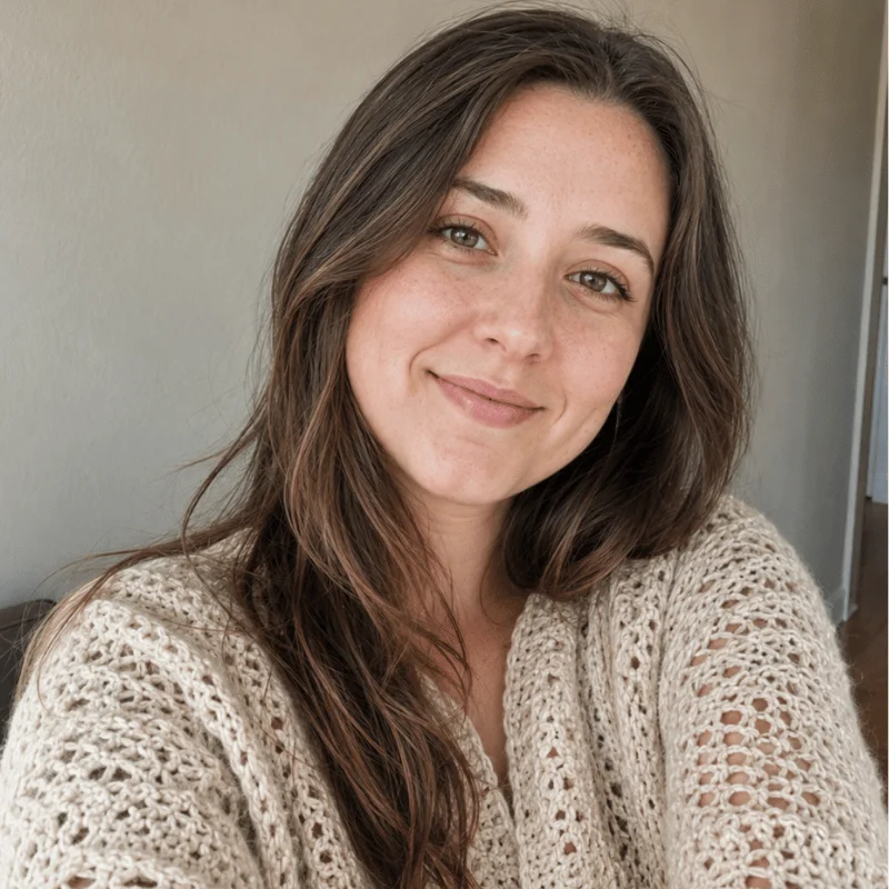 Lily from AmiLoops smiling in a handmade cream crochet cardigan.
