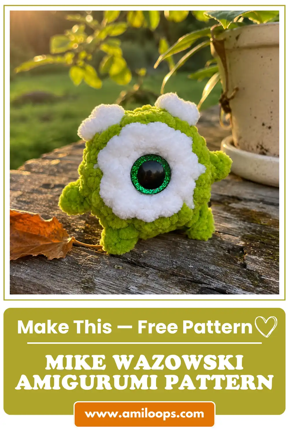 Green plush toy with one eye on wood in sunlight, made using the mike wazowski amigurumi pattern free.