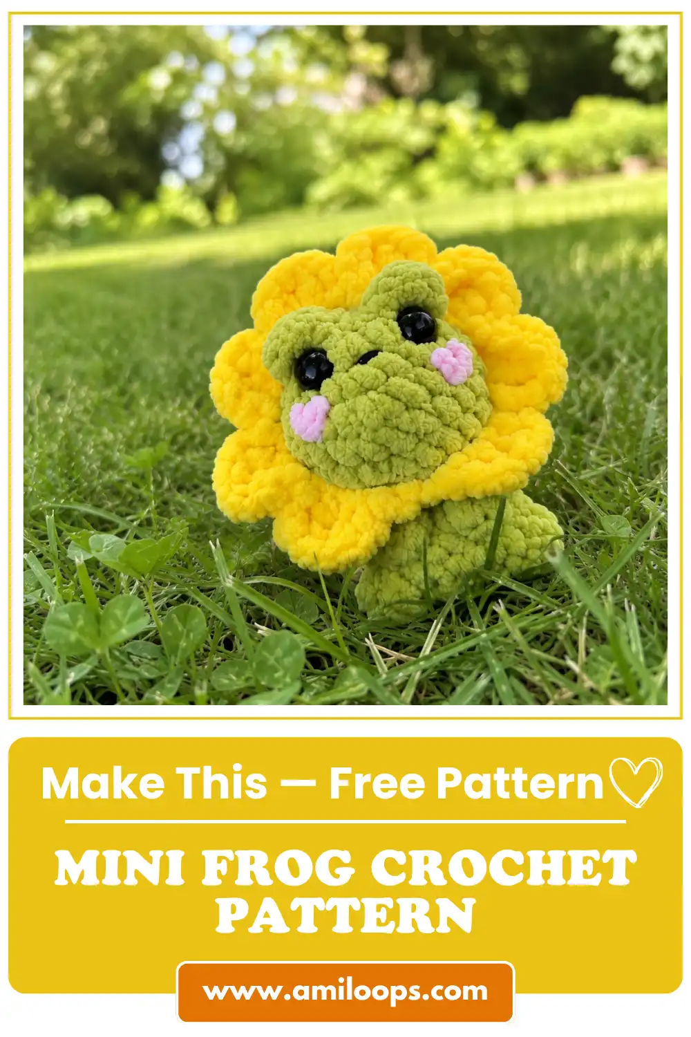 A green plush mini frog crochet pattern with a yellow flower petal collar sitting outside on bright green grass in the sun.