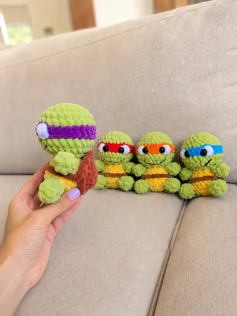 Side view of a green toy with a purple mask from a teenage mutant ninja turtles amigurumi free pattern, held over a couch.