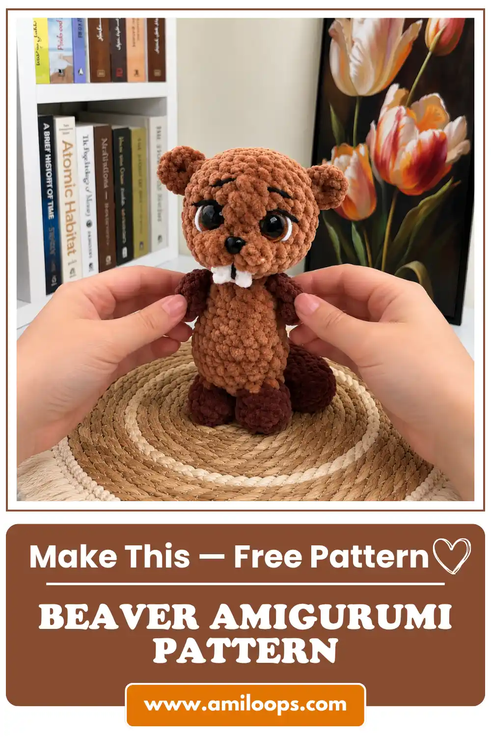 Hands holding a cute brown plush beaver amigurumi toy with big eyes and white teeth on a straw placemat.