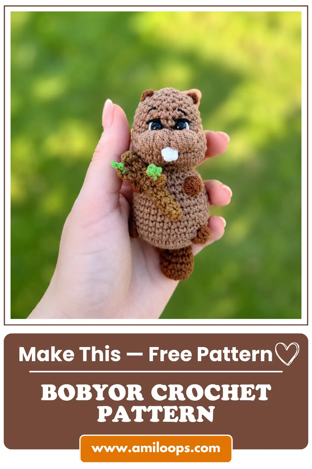 Hand holding an amigurumi brown yarn beaver against green grass using the Bobyor crochet pattern.