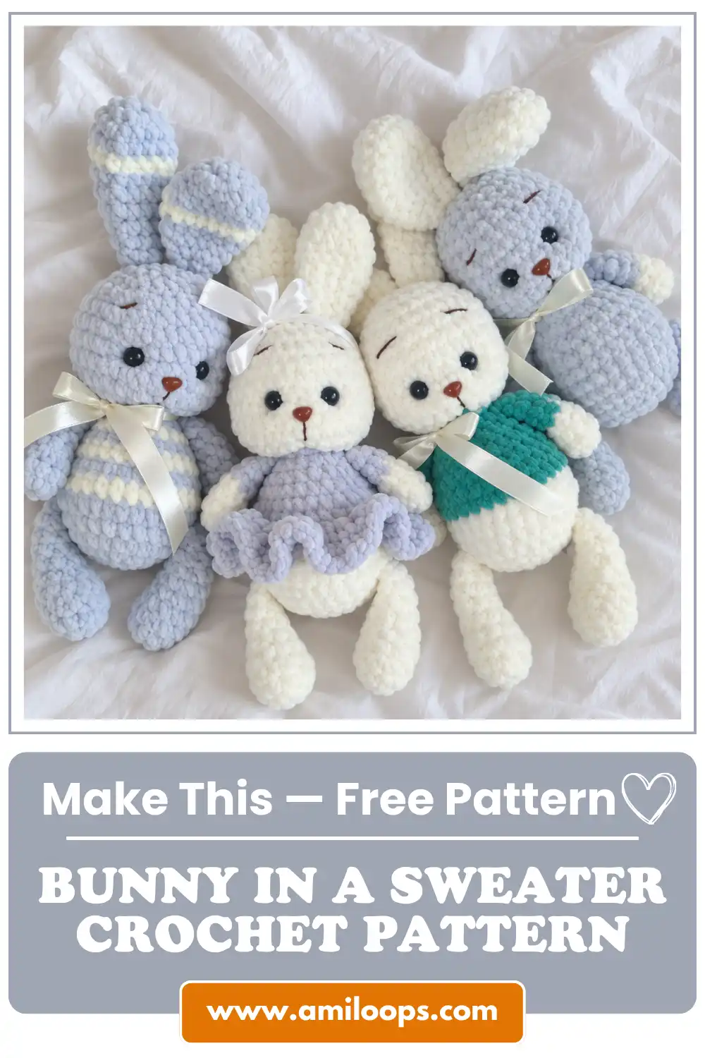 A bunny in a sweater crochet pattern shown with three other chunky yarn bunnies resting on a soft white wrinkled fabric.