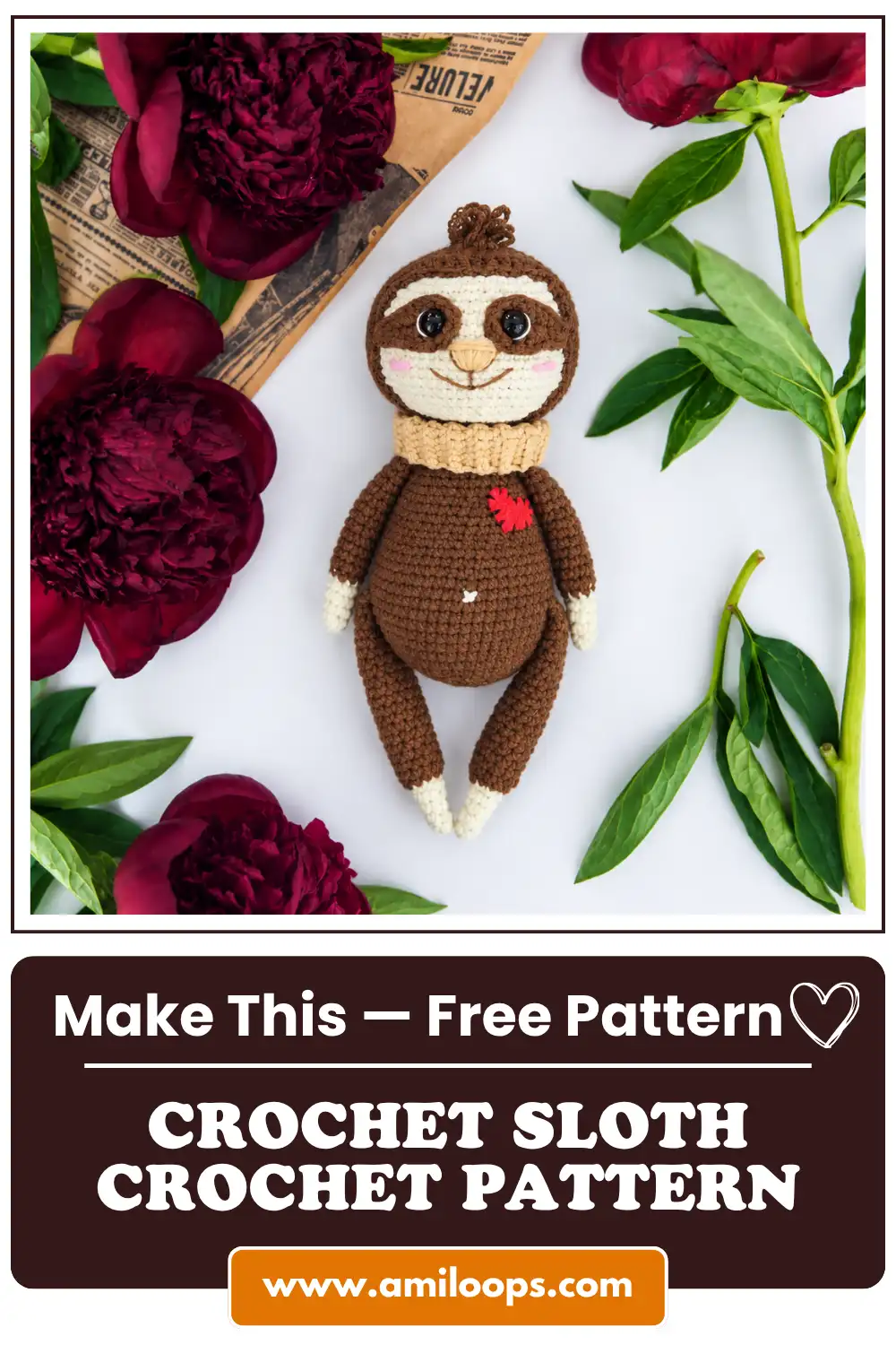 Brown yarn toy from a crochet sloth pattern laid on a white background, surrounded by dark red peonies and newspaper.