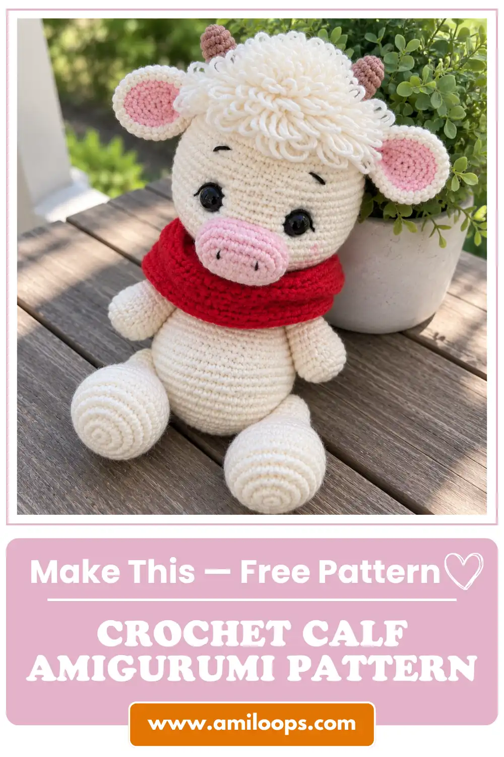 White yarn crochet calf amigurumi pattern with red scarf sitting on an outdoor wooden table beside a green plant.