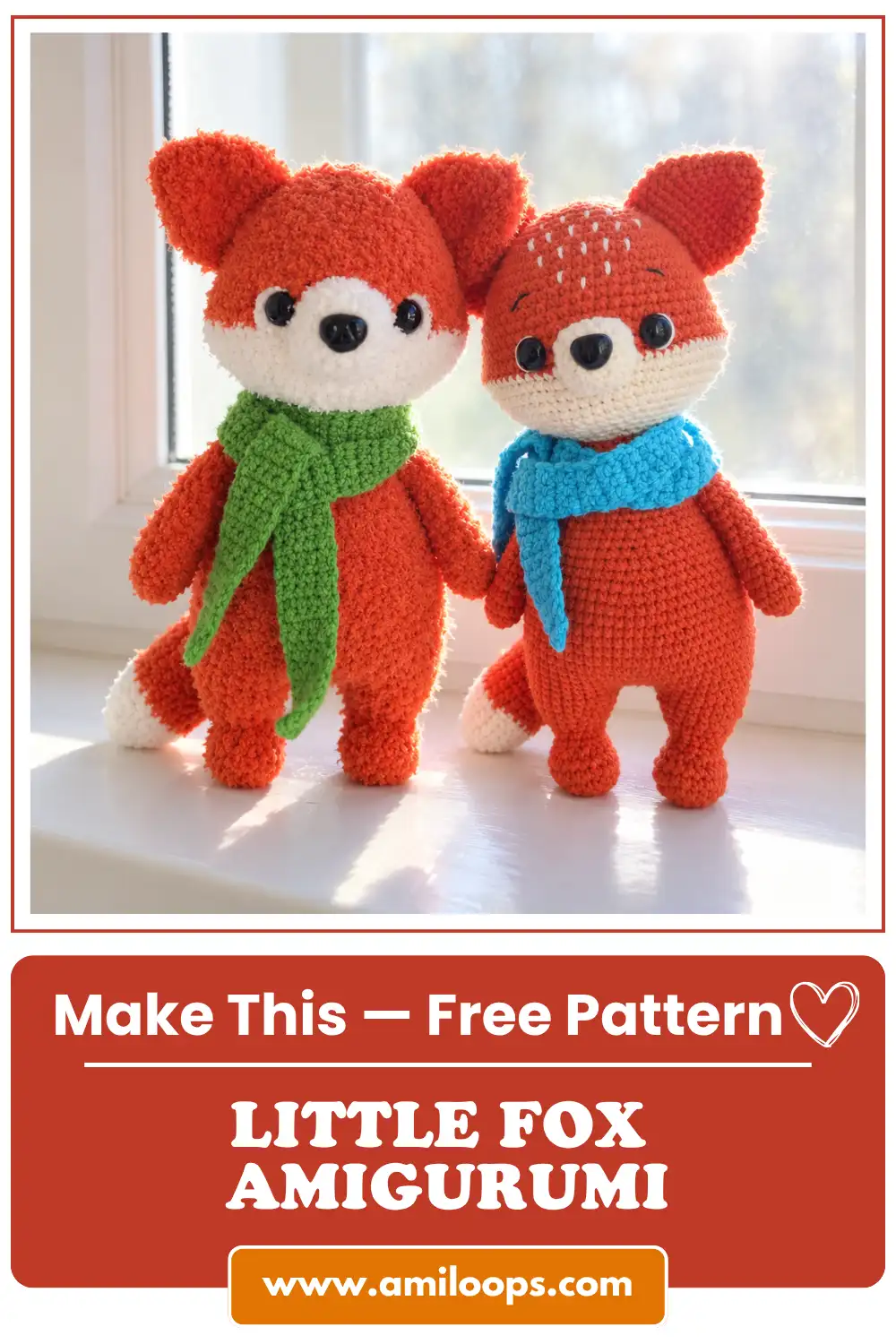 Two fluffy orange yarn toys from a fox amigurumi pattern wearing green and blue scarves on a sunlit windowsill.