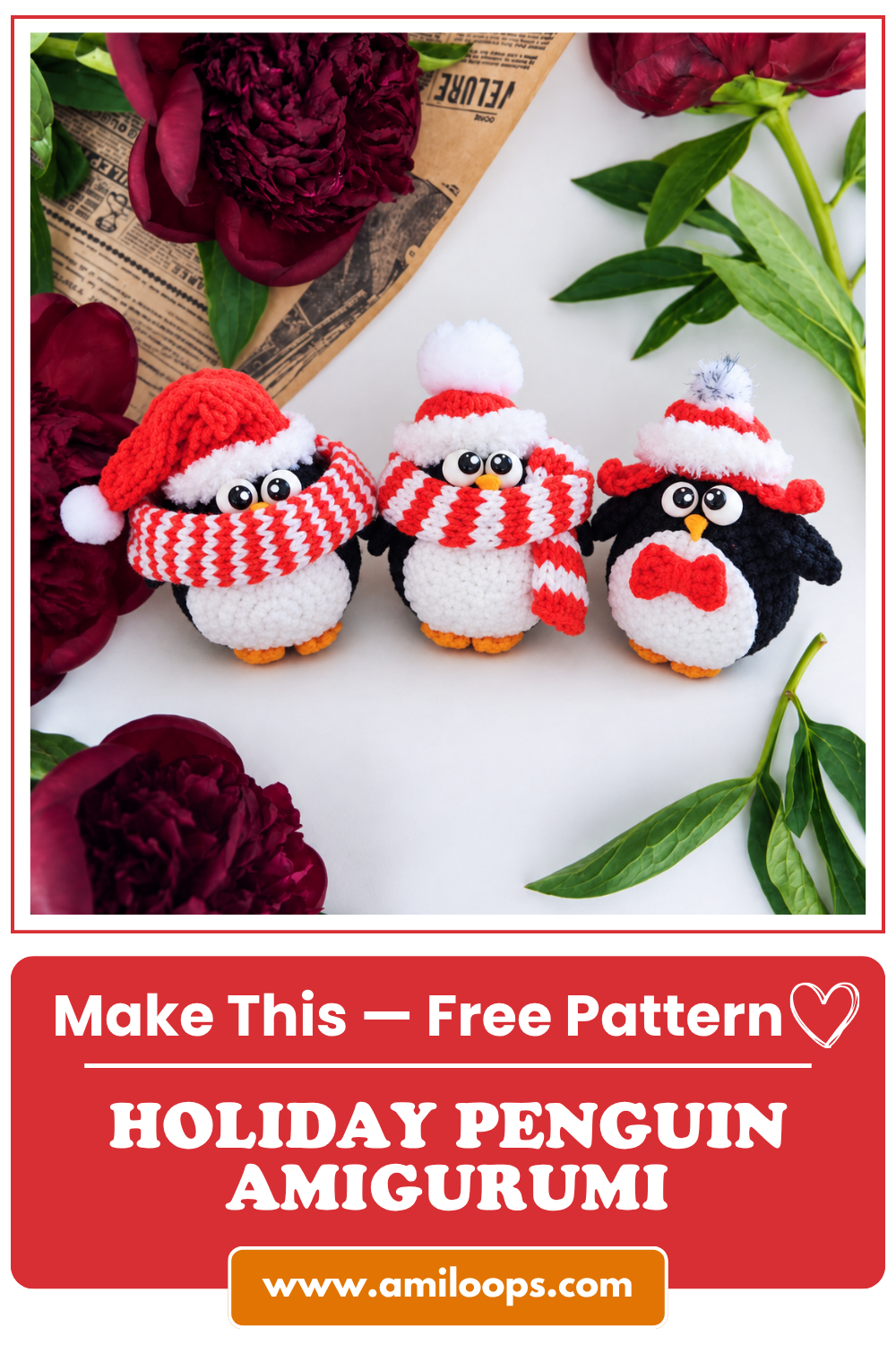 Top view of three holiday penguin amigurumi toys in red winter hats, framed by dark red peonies and vintage newspaper.
