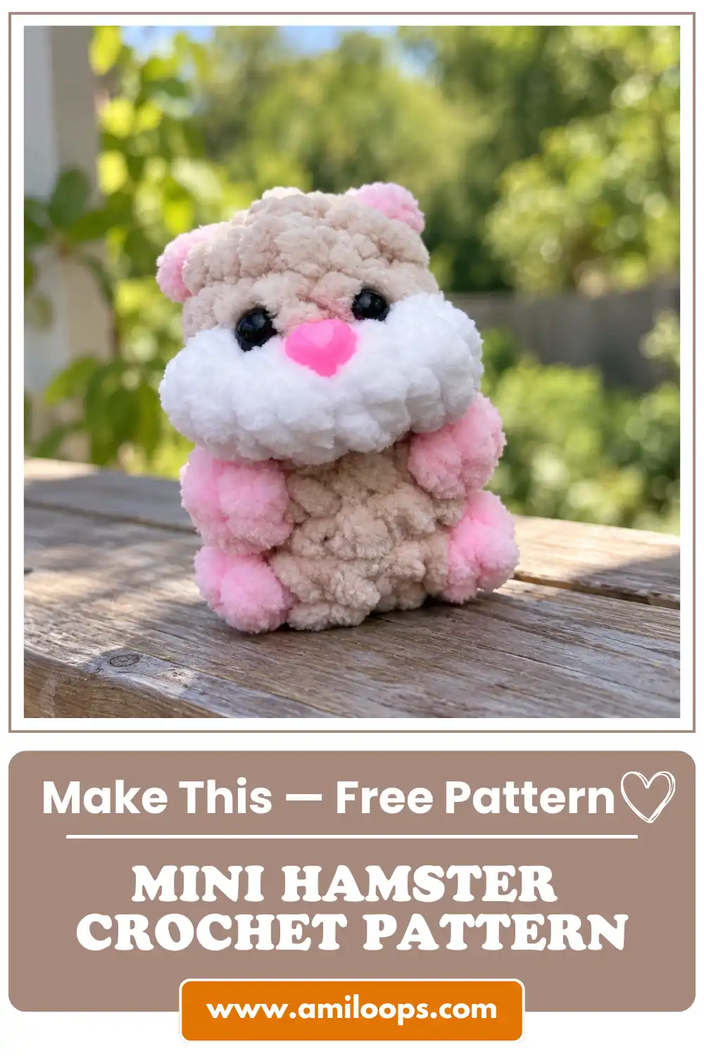 A plush beige and pink toy from a mini hamster crochet pattern sitting on a wooden deck with a blurred green garden behind.