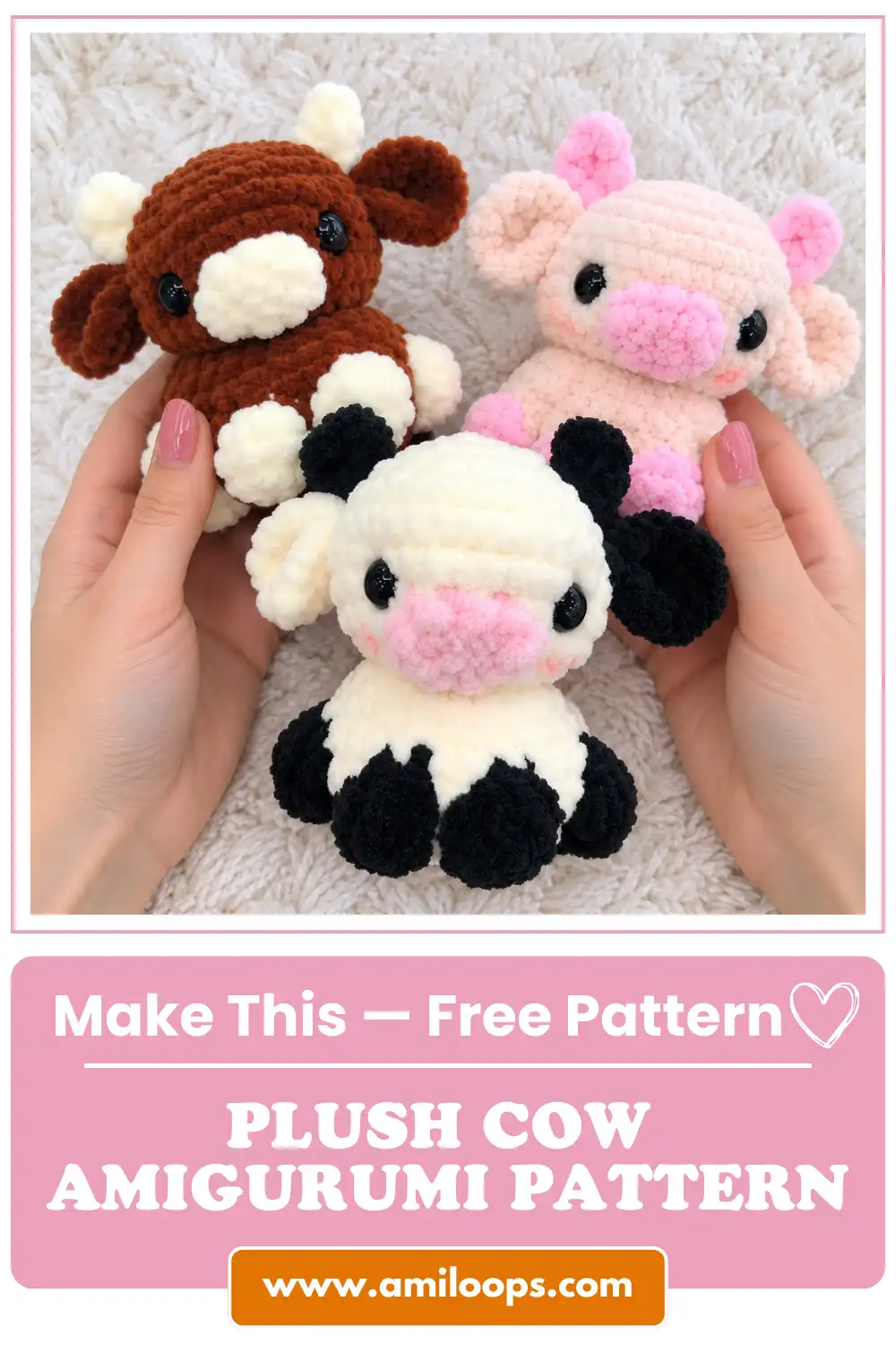 Two hands holding three colorful handmade plush cow amigurumi toys over a soft knitted white blanket.