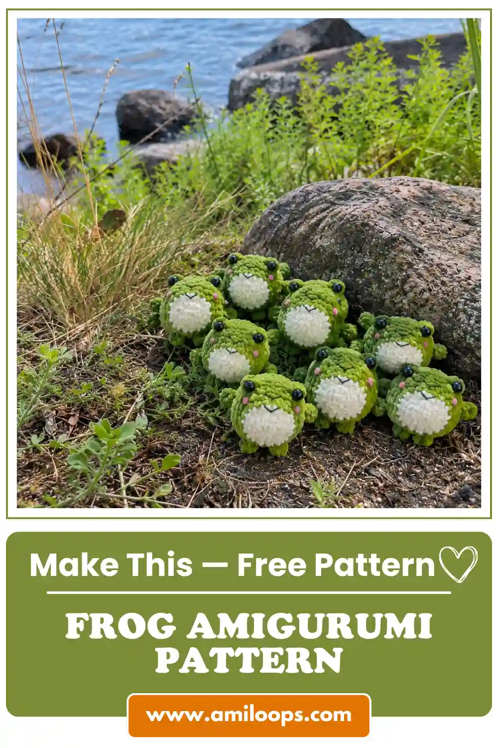 Several green and white crochet velour frog amigurumi toys outdoors near a large rock and lake.