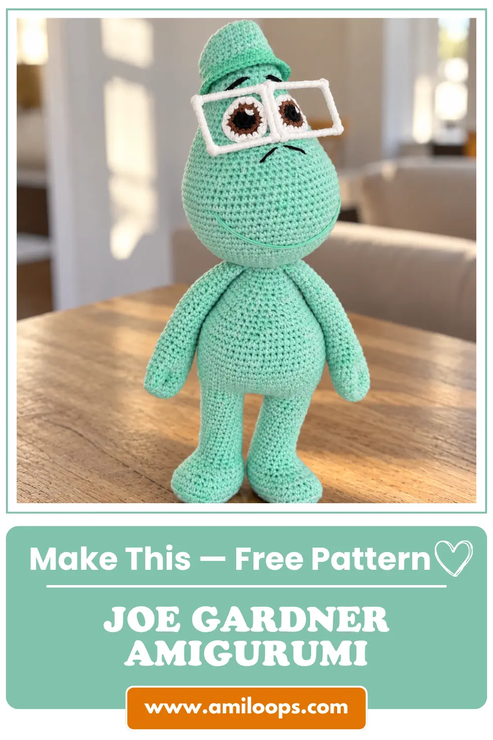 Mint green crochet joe gardner amigurumi doll with square glasses standing on a wooden table in bright daylight