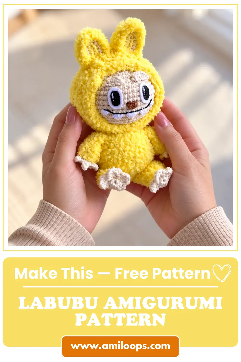Close-up of two hands holding a textured yellow plush amigurumi toy in soft window light.